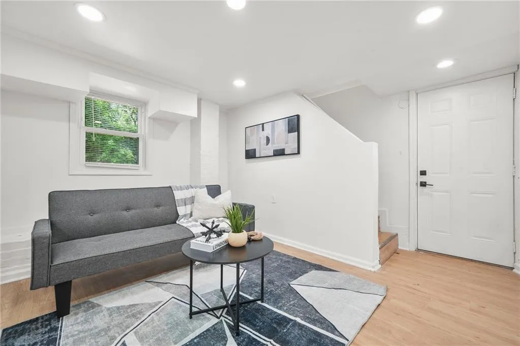 Living area featuring light wood finished floors, stairs, and recessed lighting