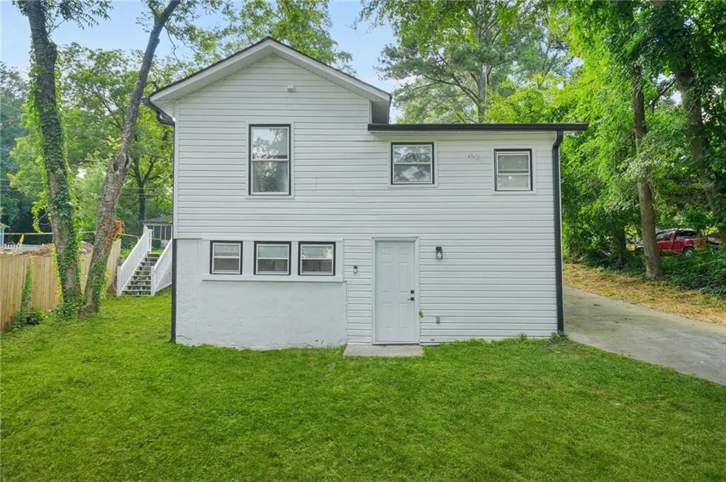 Back of house featuring stairway