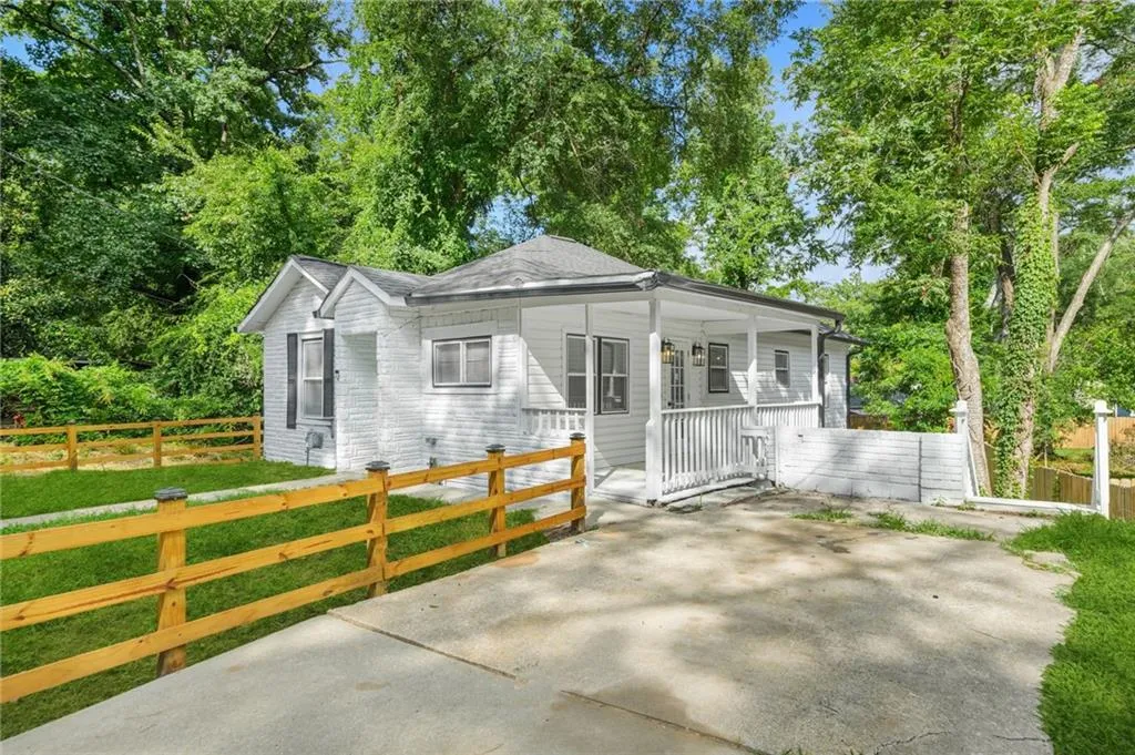 Bungalow-style home featuring a porch and roof with shingles