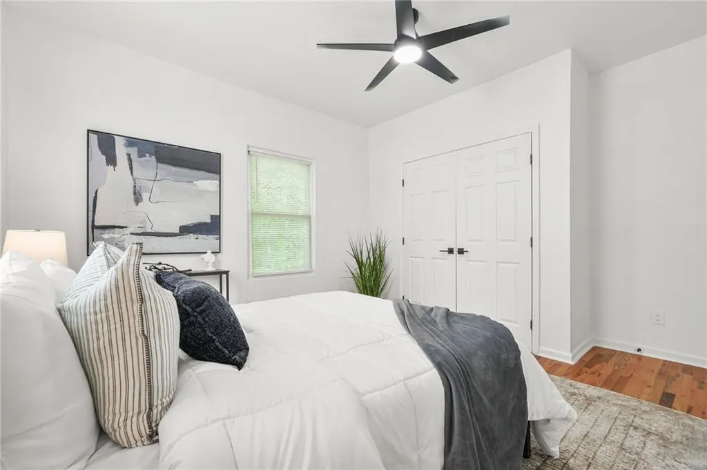 Bedroom featuring wood finished floors, a ceiling fan, and a closet