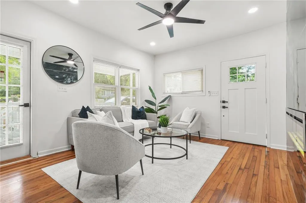 Living room featuring plenty of natural light, hardwood / wood-style flooring, a ceiling fan, and recessed lighting