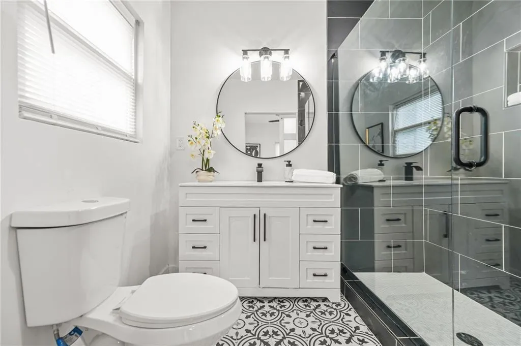 Bathroom with vanity, a stall shower, and tile patterned floors
