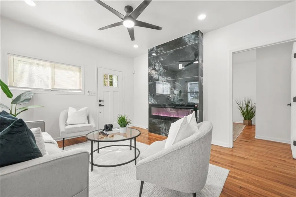 Living room featuring ceiling fan, wood finished floors, and recessed lighting