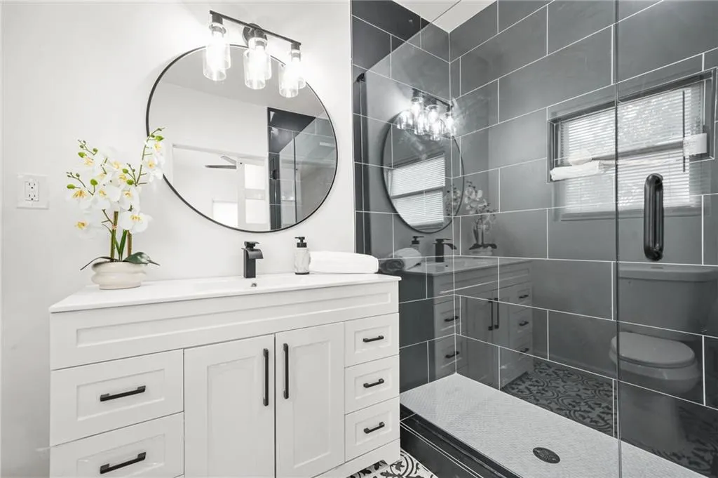 Full bath with vanity and a shower stall