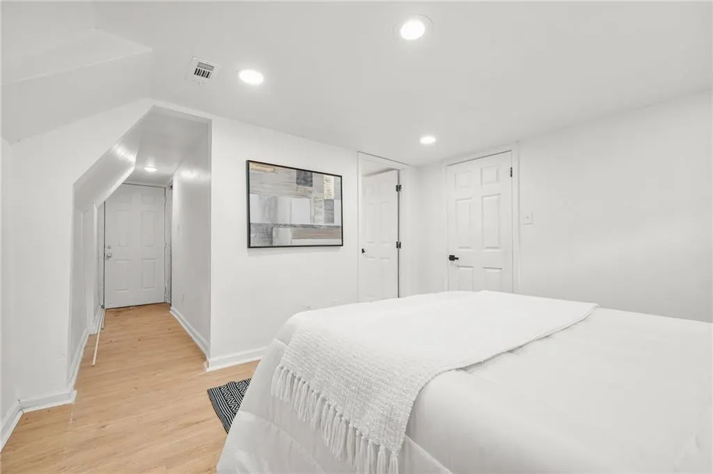 Bed - Lower LevelBedroom with light wood finished floors and recessed lighting