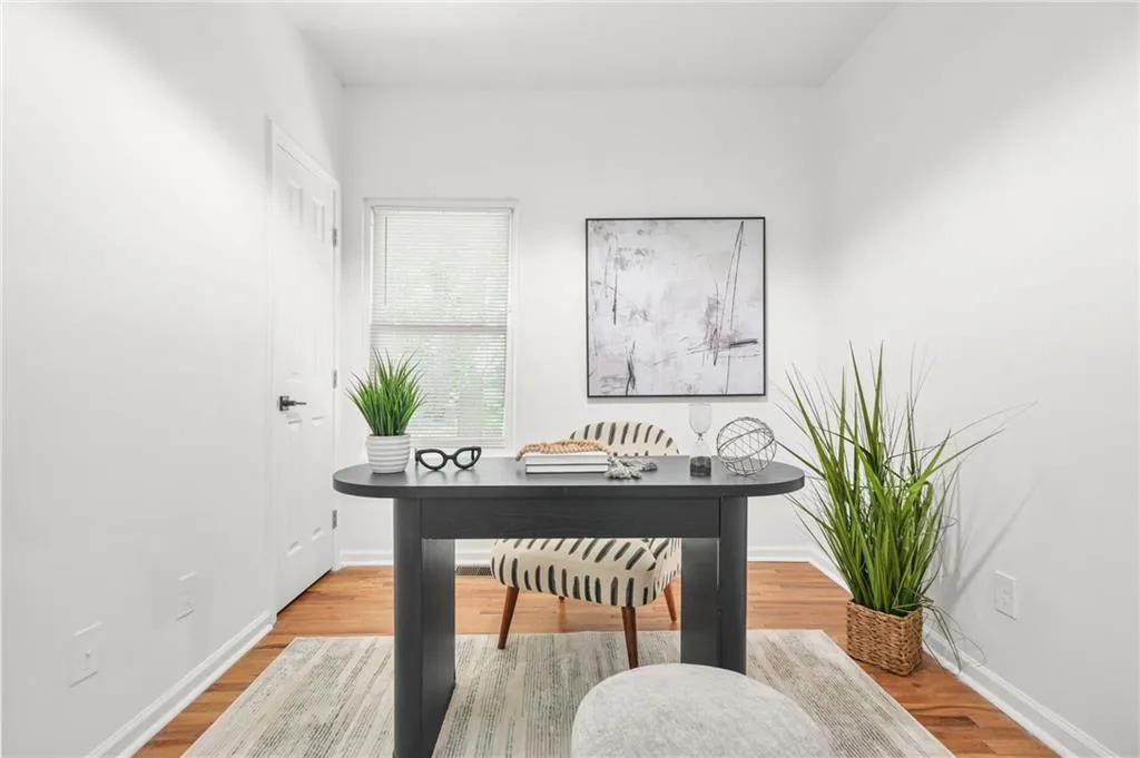 Office area with baseboards and wood finished floors
