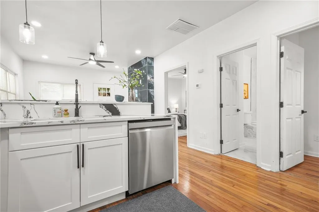 Kitchen featuring white cabinetry, dishwasher, recessed lighting, ceiling fan, and light wood-style flooring