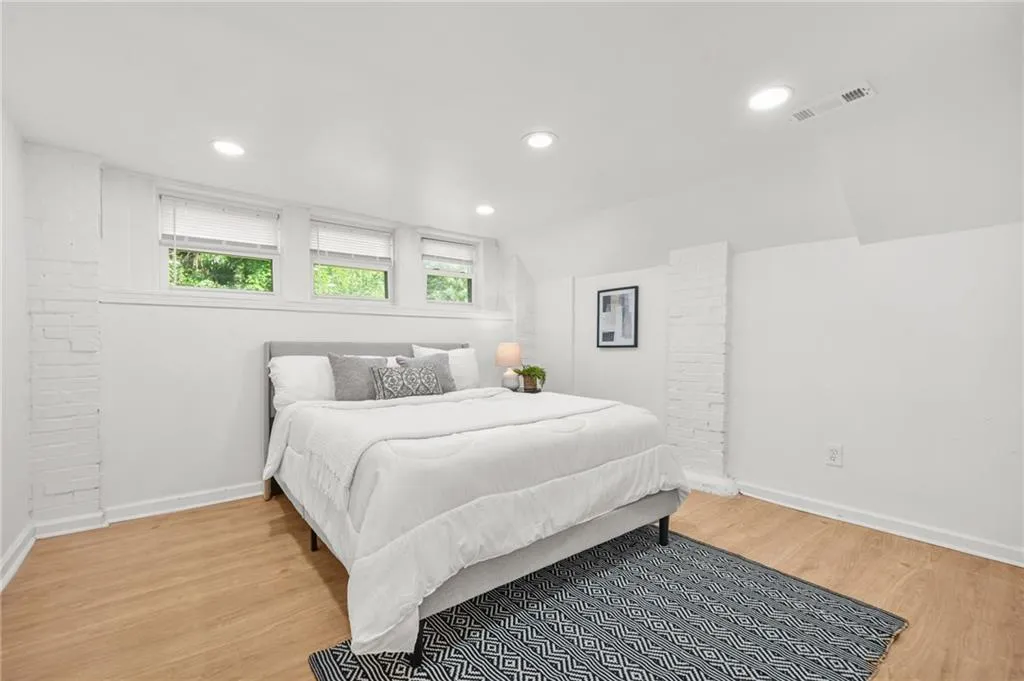 Bedroom with wood finished floors and recessed lighting