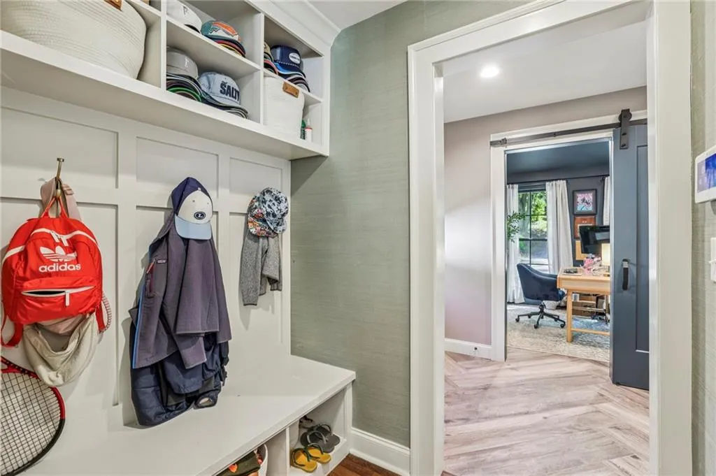 Mudroom with parquet flooring and a barn door