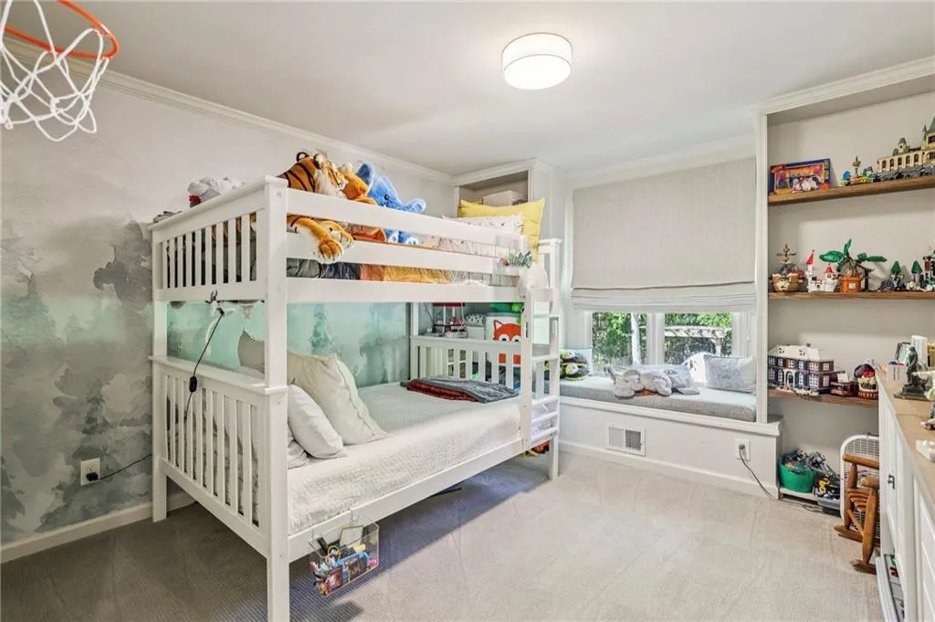 Bedroom featuring crown molding and light carpet