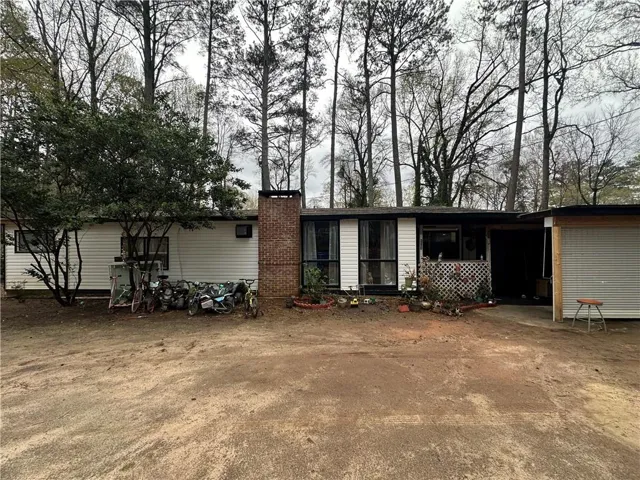 View of front of home featuring a chimney