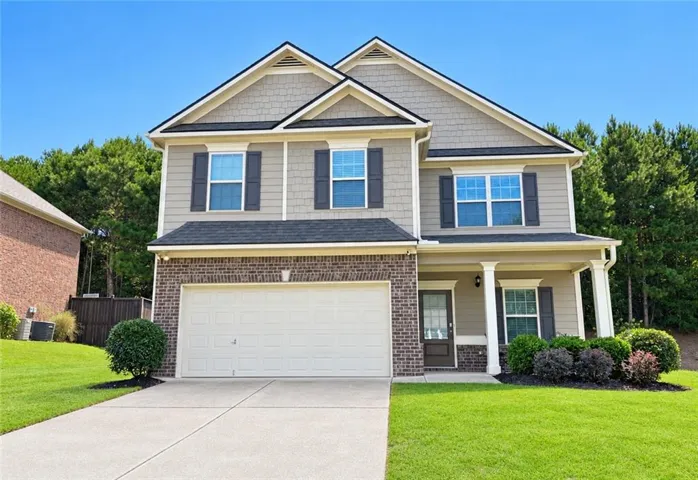 Two-story exterior with brick and siding facade, covered front porch with pillars, and an attached garage with a paved driveway. Exterior photos may have been virtually enhanced, including portions of the home, lawn, sky, driveway, and landscaping. Actual conditions may vary.