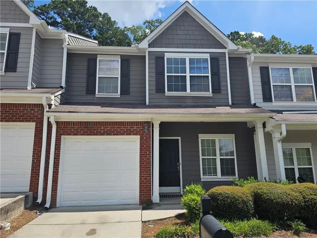 Mixed material exterior featuring brick and siding