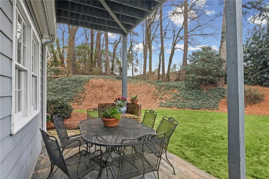 Fenced backyard with outdoor dining space and a patio area