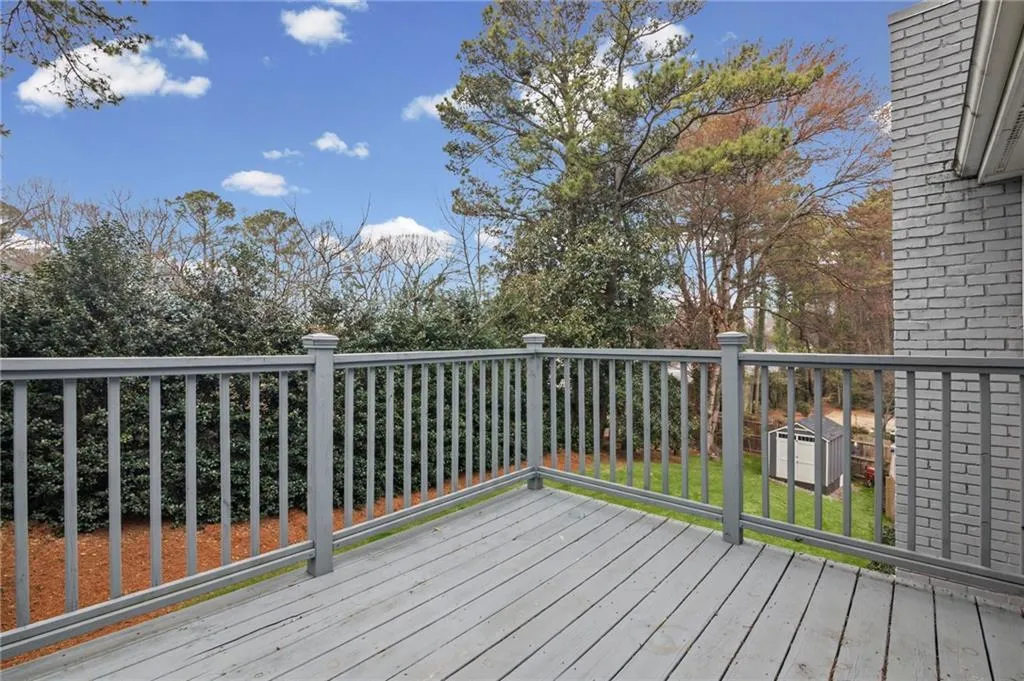Deck featuring a shed