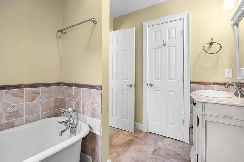 Bathroom featuring vanity and a soaking tub