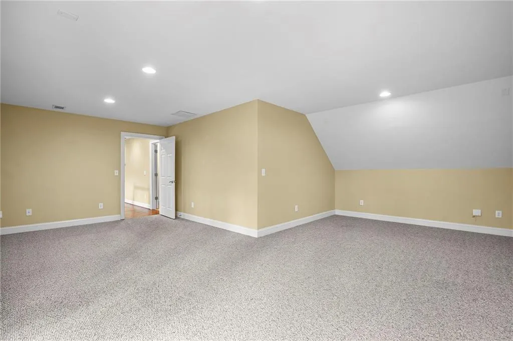 Bonus room featuring recessed lighting, light carpet, and vaulted ceiling