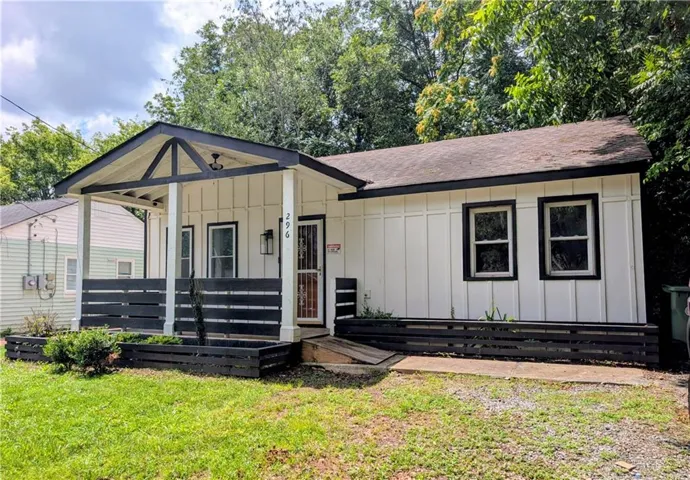 White board-and-batten siding with black trim accents