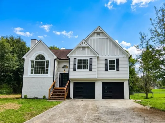 White exterior with board and batten and horizontal siding accents