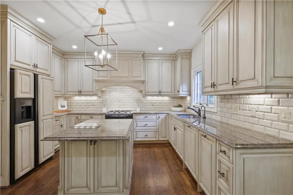 Light filled kitchen with island.