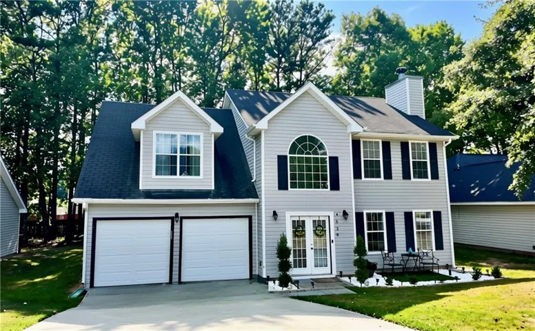 Traditional exterior with light gray siding and dark shutters