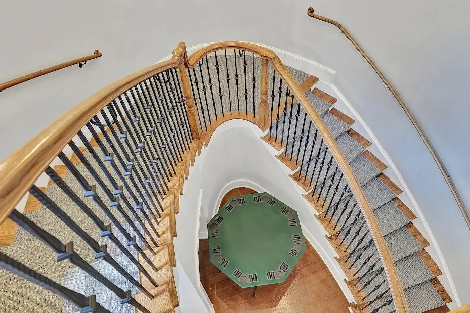 Stairs with light hardwood / wood-style flooring