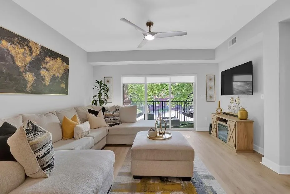 Living room with light hardwood / wood-style flooring and ceiling fan