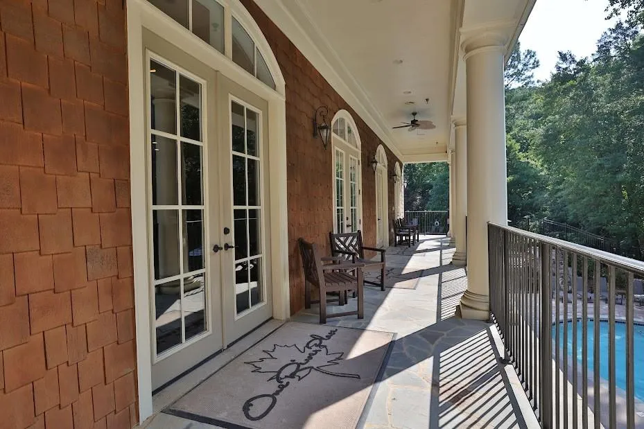 Balcony featuring french doors and a fenced in pool