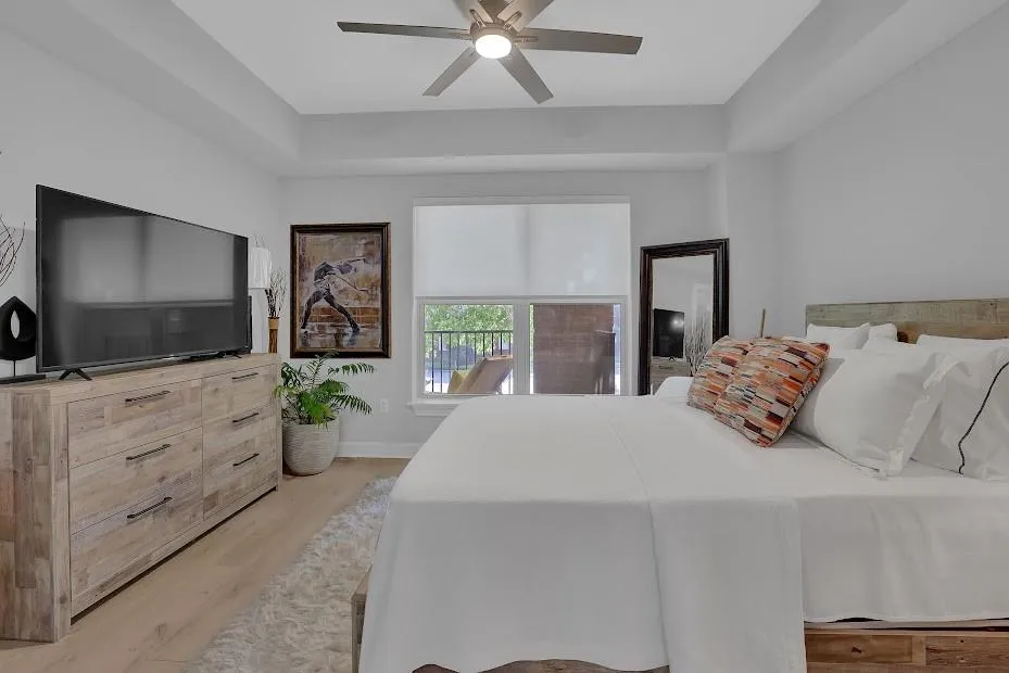 Bedroom with ceiling fan and light hardwood / wood-style flooring