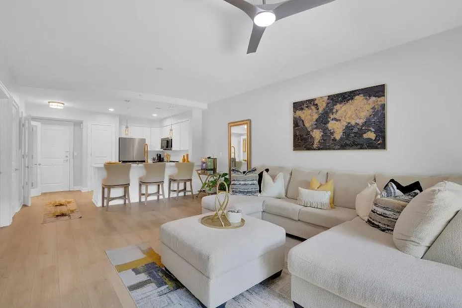 Living room with light hardwood / wood-style flooring and ceiling fan