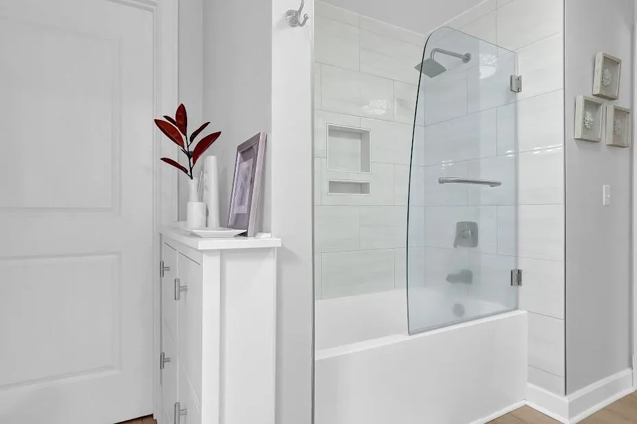 Bathroom featuring shower / bath combination with glass door and hardwood / wood-style floors