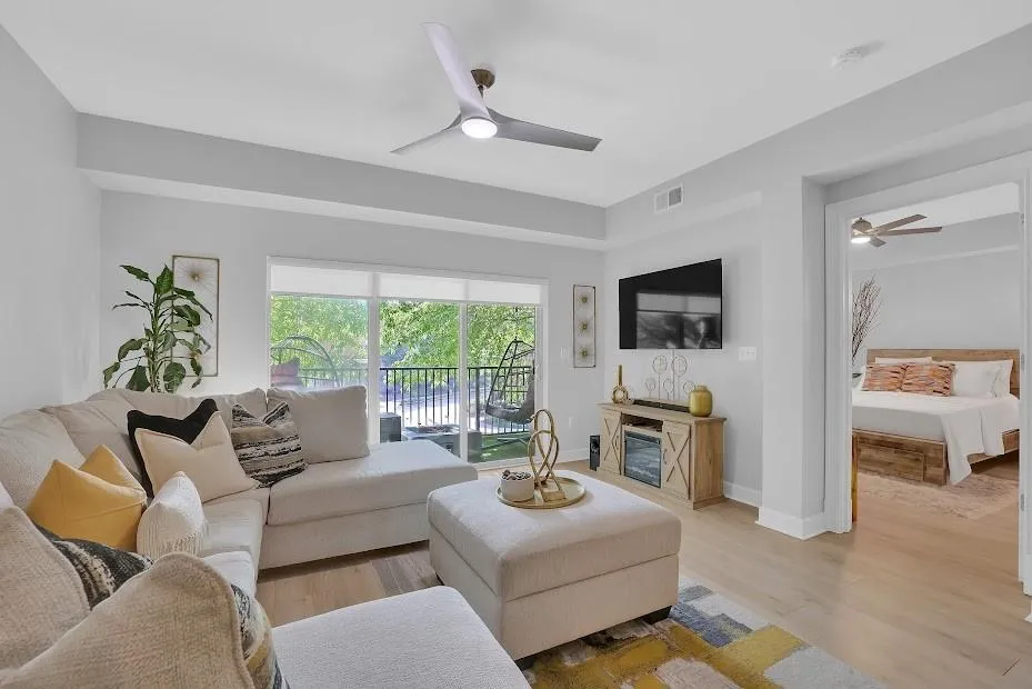 Living room with light wood-type flooring and ceiling fan