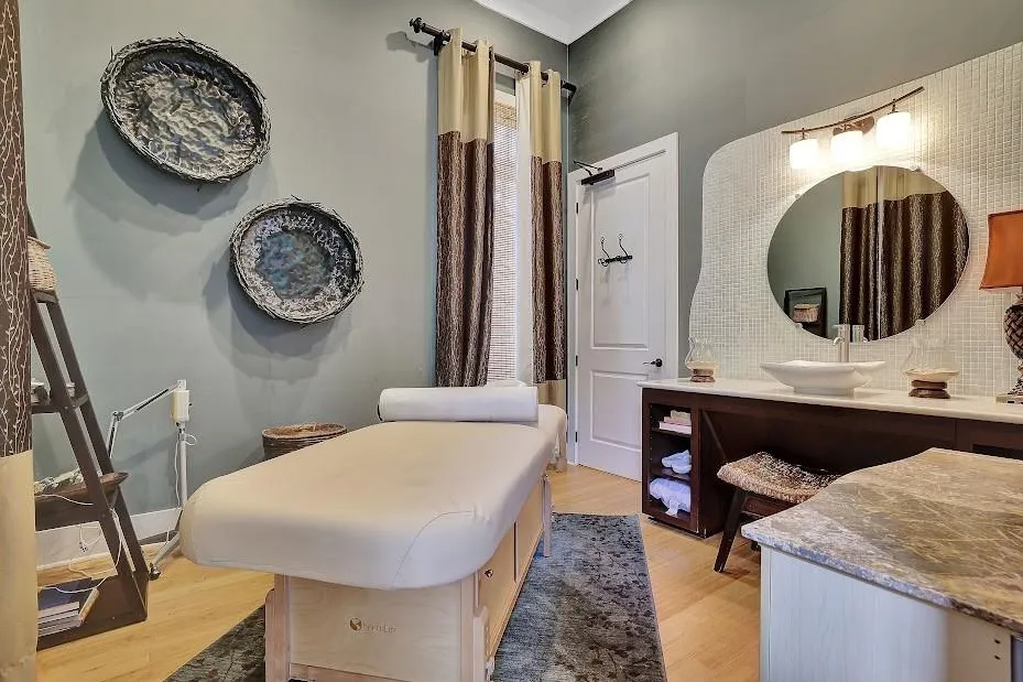 Bathroom featuring backsplash, vanity with extensive cabinet space, and hardwood / wood-style floors