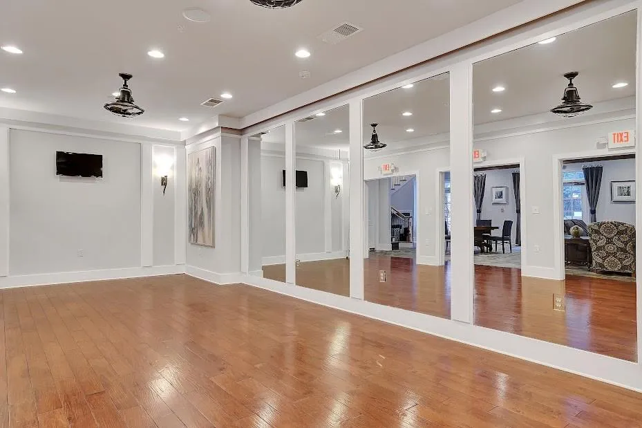 Exercise area featuring hardwood / wood-style flooring and crown molding