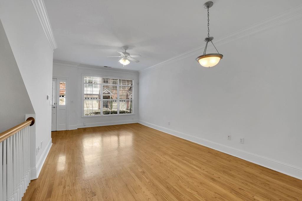 Spare room featuring light hardwood / wood-style floors, ceiling fan, and ornamental molding