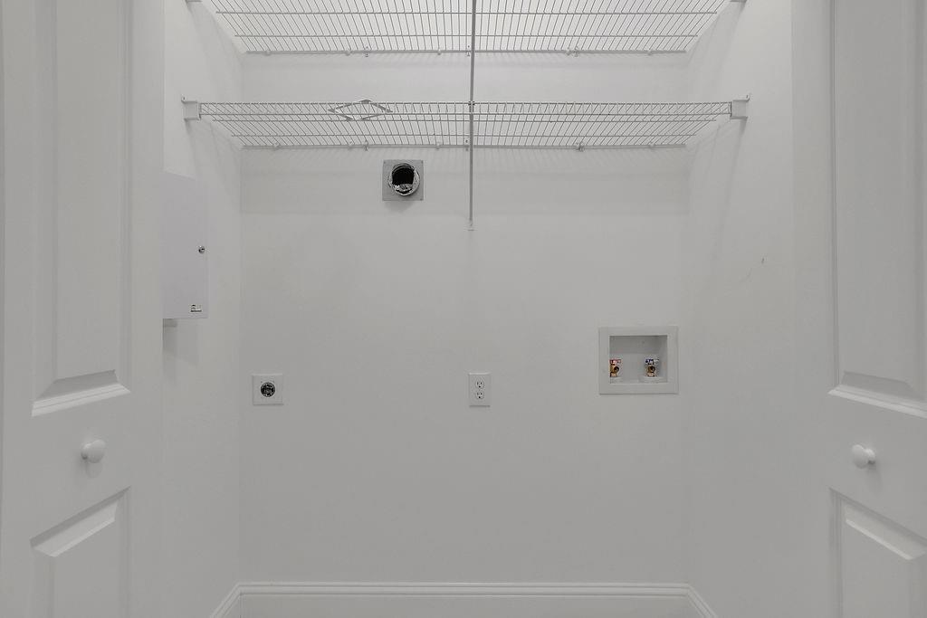 Washroom with hookup for a washing machine and hookup for an electric dryer