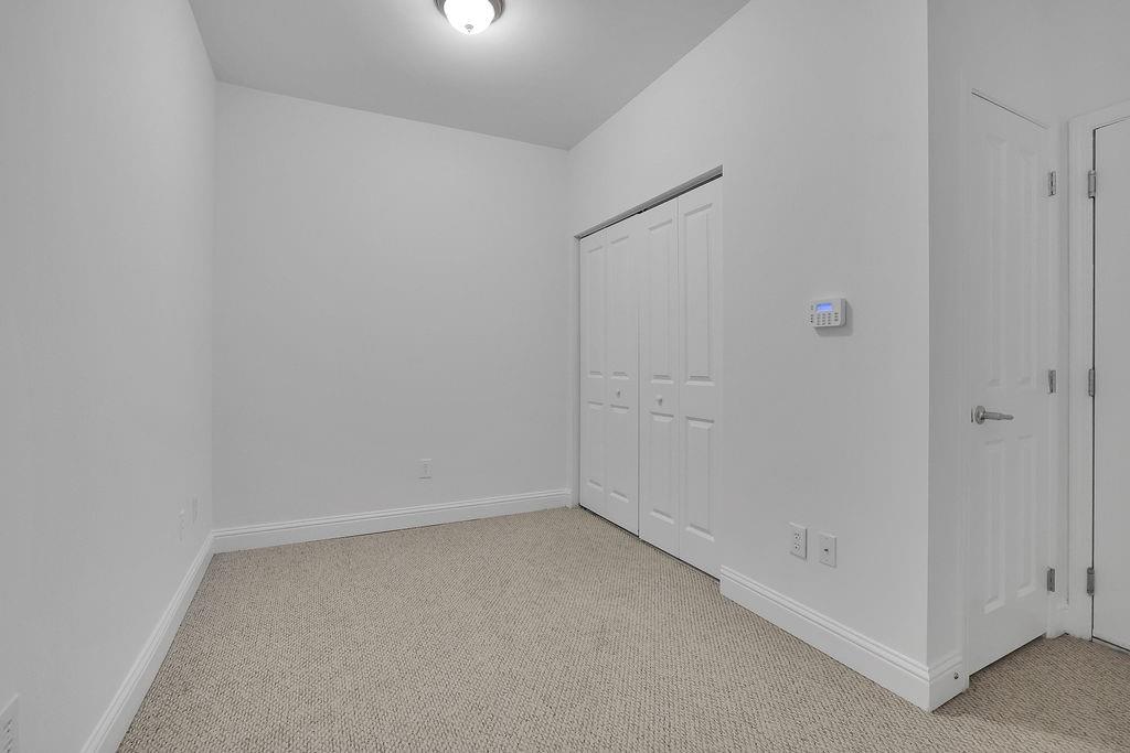 Unfurnished room with light carpet