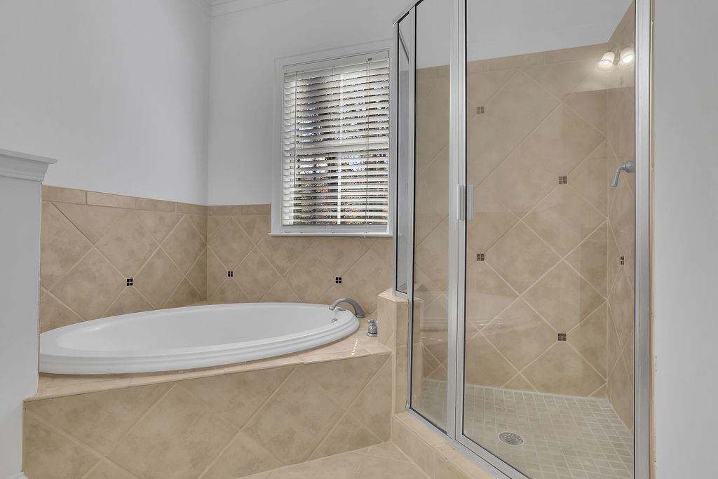 Bathroom featuring tile floors and independent shower and bath
