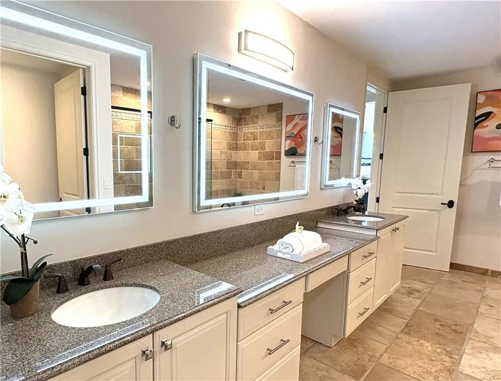 Bathroom featuring double vanity and vanity Bathroom featuring double vanity and vanity