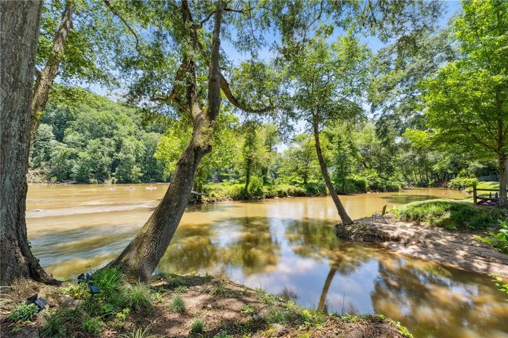 Water view with a heavily wooded area