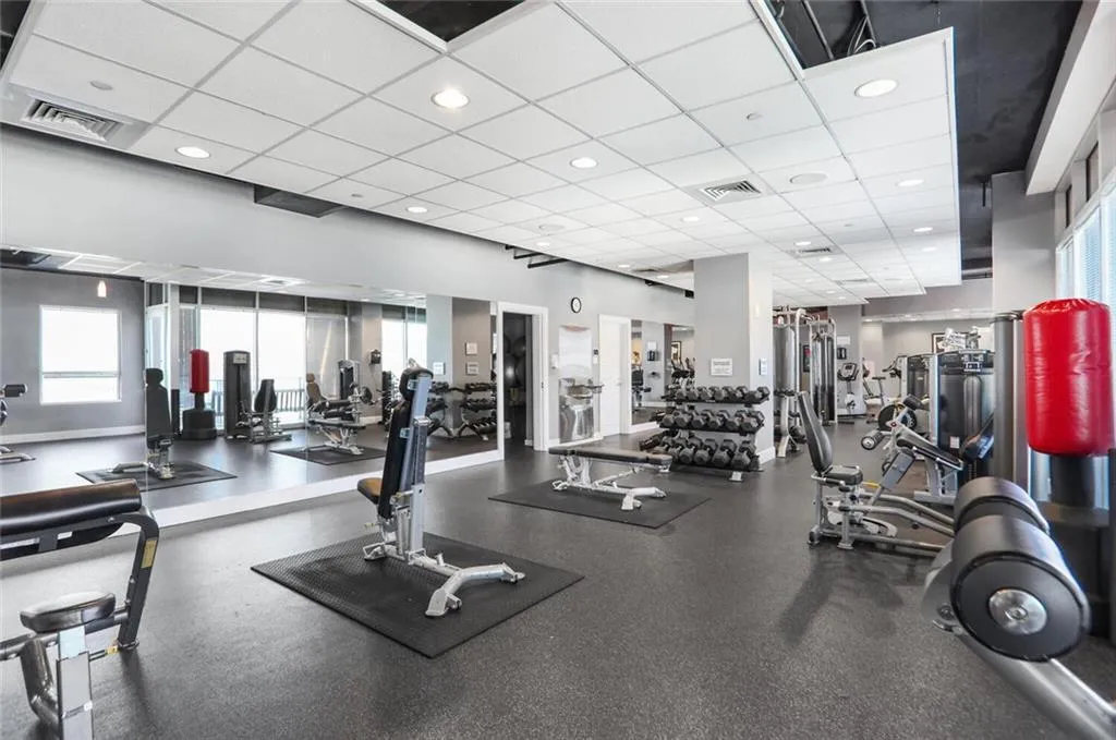 Gym featuring visible vents, recessed lighting, and a paneled ceiling