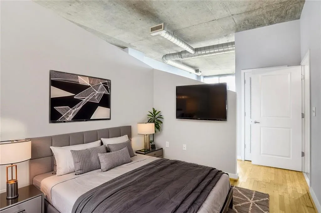 Bedroom with visible vents and wood finished floors