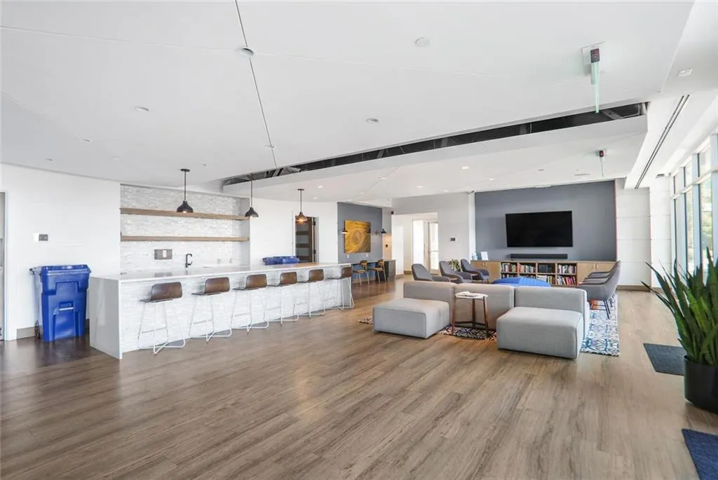Living area with wood finished floors and recessed lighting