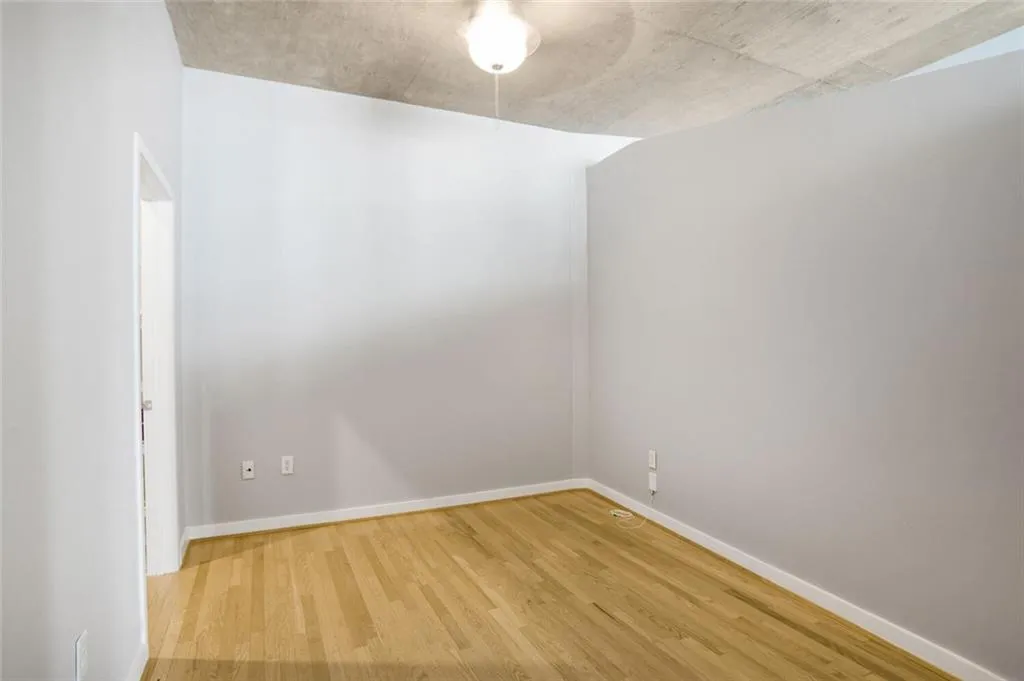 Spare room featuring baseboards and wood finished floors