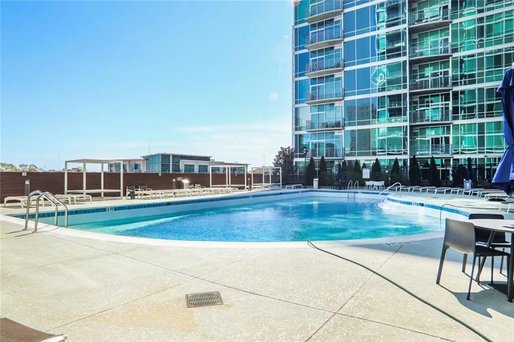 Community pool with fence and a patio