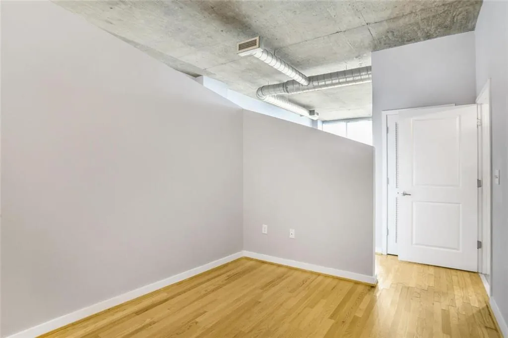 Unfurnished room with baseboards, visible vents, and light wood-style flooring