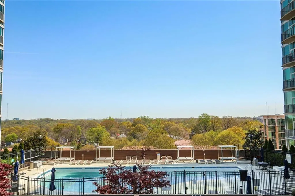 Community pool with fence and a patio area