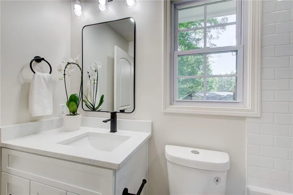 En-Suite Bathroom  upstairs with pretty  vanity and bathtub