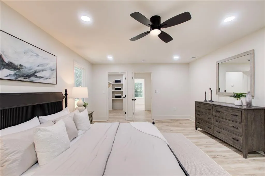 The primary suite has a great closet with lots of storage. Across the all is an en-suite bedroom