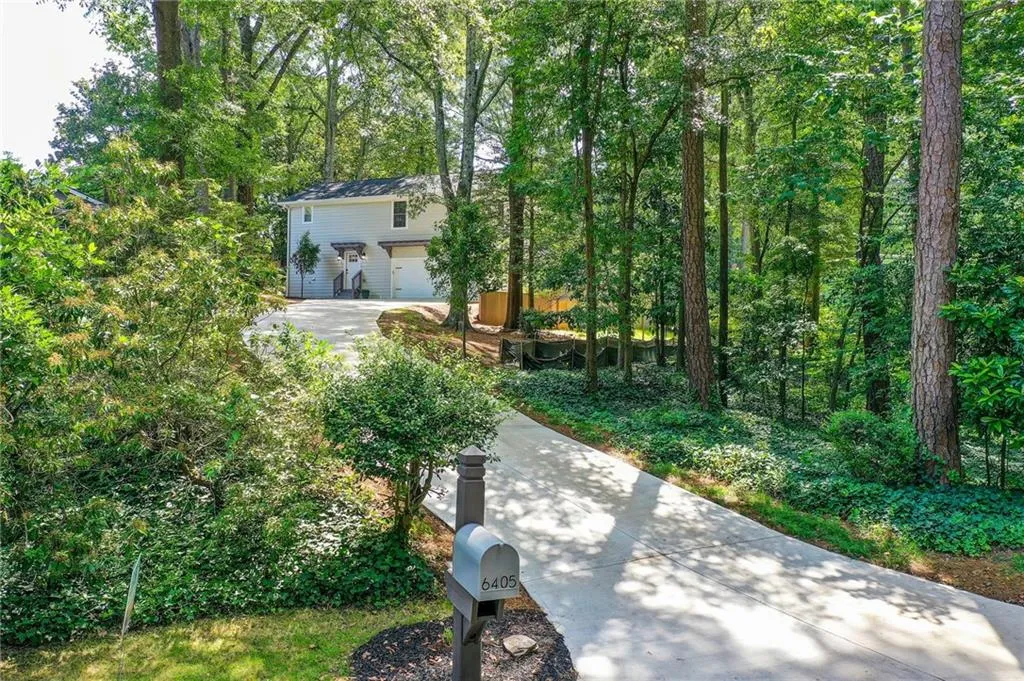 View of yard featuring driveway and a garage